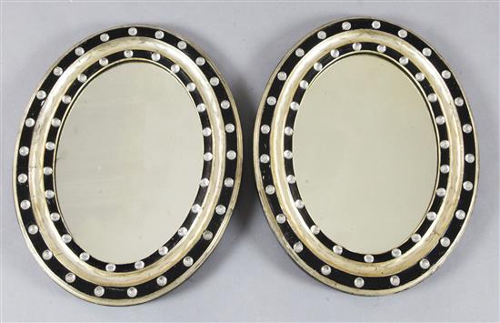 A pair of Regency Irish ebonised and silvered wall mirrors, H.1ft7in. W.1ft3in.